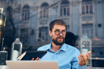 man in blue shirt laptop communication technology