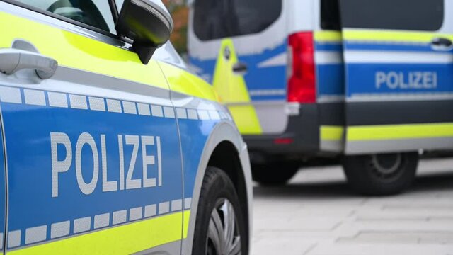 German police cars on the street. Side view of a police car with the lettering "Polizei".  Police patrol car parked on the street in Germany.
