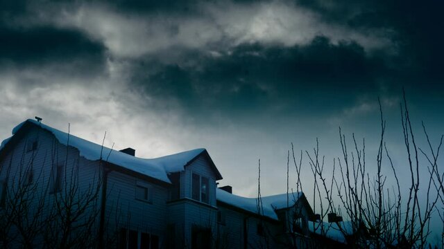Dark Clouds in the sky over Horror Scary Haunted House. Halloween.