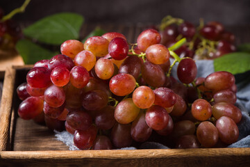 fresh ripe red seedless grapes  on wood table