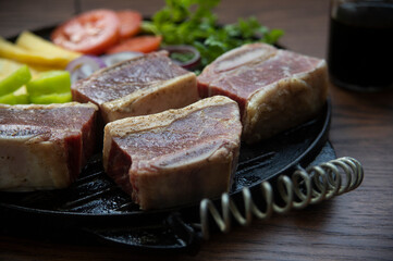 BEEF CUT INTO PIECES, WITH VEGETABLES SUCH AS TOMATO, ONION, PARSLEY, PEPPERS AND POTATOES, ON...