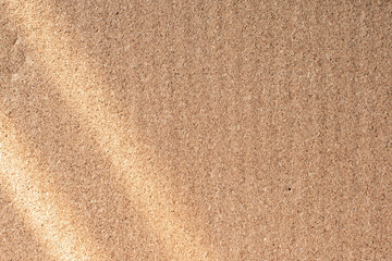 Fototapeta na wymiar sunlight shadow overlay on abstract brown paper background texture
