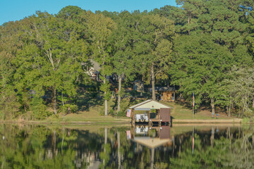 Fototapeta na wymiar Mirror Image on Lake Cherokee of boat houses and trees. In East Henderson, Rusk County, Texas