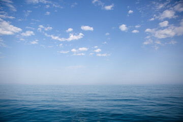 Blue sea and sky with white clouds