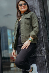 Young Beautiful Asian Woman Wearing Jacket And Black Jeans Posing Outdoors