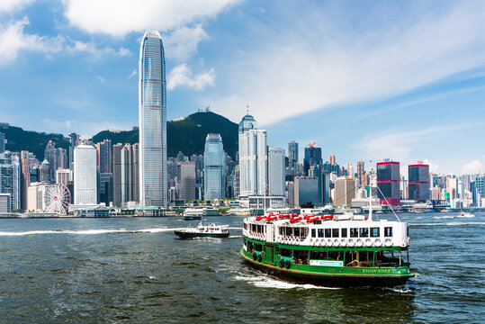 Hong Kong - July 16, 2019: Star Ferry on the way to Central Pier Harbor with skyscrapers of Hong Kong Victoria Harbour in the background.