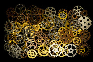 Cogs and watch pieces on black background