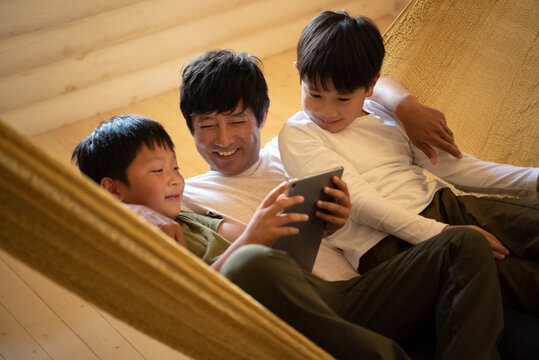 Father and Sons Relaxing in Hammock