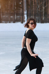 figure skater on ice. the girl is skating. ice under the open sky. No makeup in winter, red cheeks