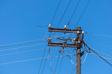 cable clutter on electric pole and ceramic insulator,