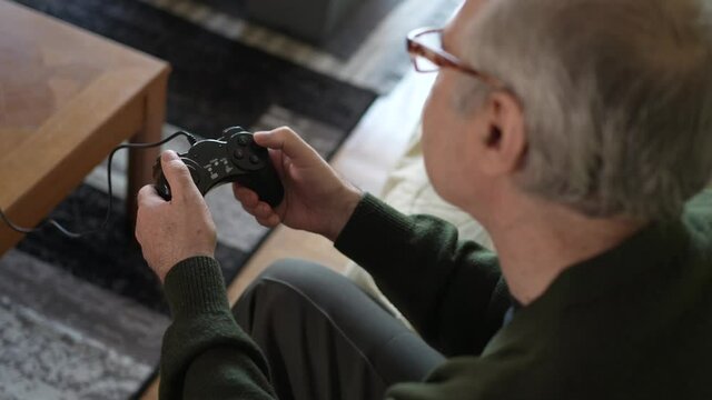 Ederly Senior Men Playing a Video Game With a Controller