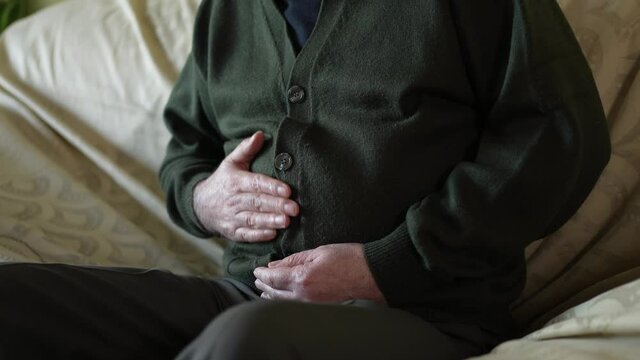 Elderly Men Suffering From Stomach Pain Rubing His Belly