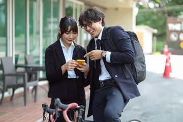 Businessman and female worker enjoy talking at the street