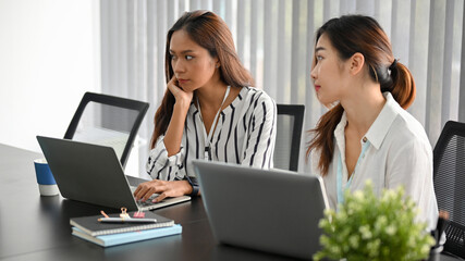 Two of asian female managers in the meeting