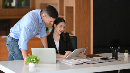 Businesspeople working and discussing new business plan in the office.