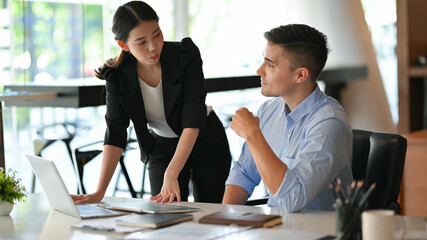 Diverse coworkers working together, asian businesswoman and caucasian male boss.