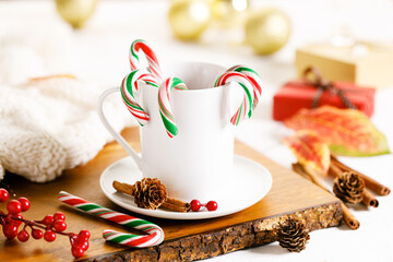 candy canes in a white cup.