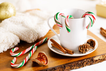 candy canes in a white cup.