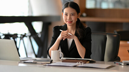 Business entrepreneur listening her employee presenting project in the meeting.