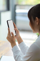 Close-up Female using mobile applications via cellphone.