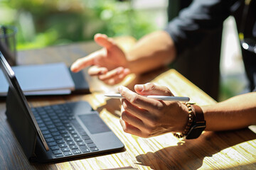 Close-up Businessman hands holding stylus pen and working on tablet