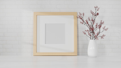 Mockup simple wooden photo poster frame on white table with flower vase over white wall.