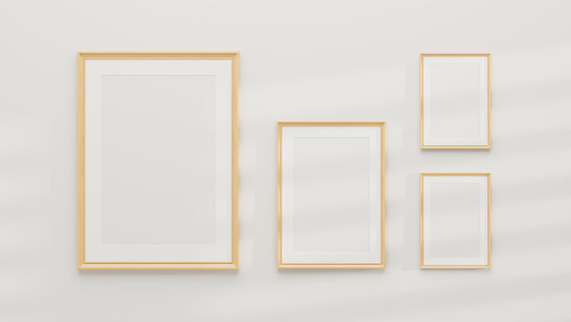 Mockup of multiple minimal wooden picture poster frames on a white wall