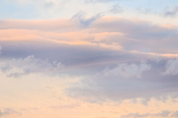 Background of blue sky with white and pink clouds in sunset. High quality photo