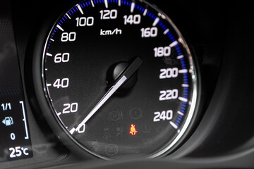Close up picture of a cars speedometer.