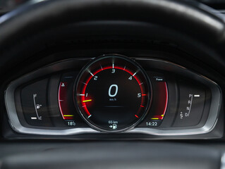 new car interior details. Speedometer, tachometer and steering wheel.