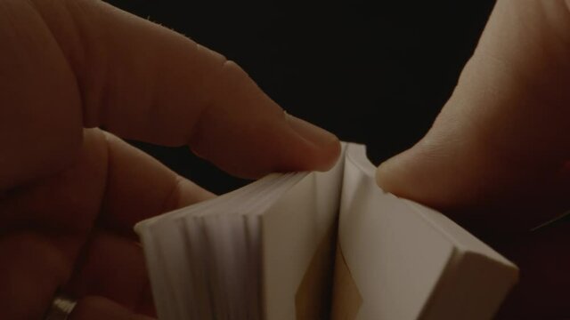 A small book being opened and the pages flipping a small push on the camera