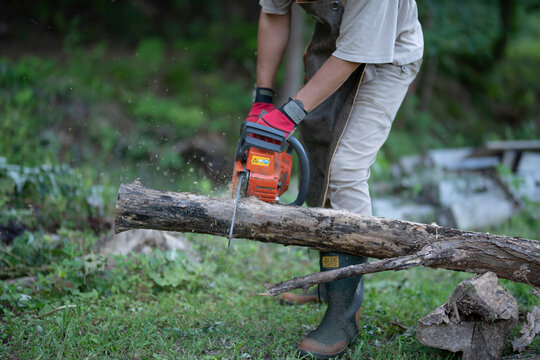 Man Cutting a Log