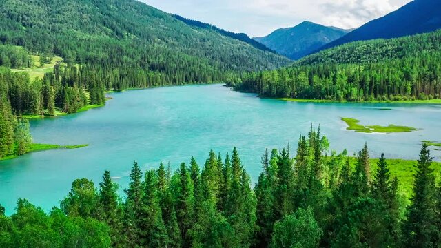 Aerial view of kanas Lake in Summer,Xinjiang,China.Green forest and mountain with river.A famous tourist destination in China.