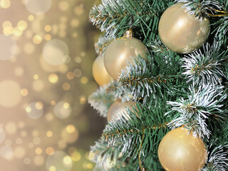 Christmas background with pine branches and golden balls.