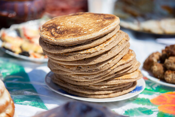 A stack of rye flour pancakes on the table.