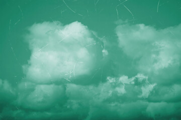 Vintage aged photo of a cloudy sky with scuffs and scratches.