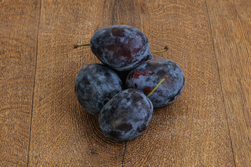 Ripe plum heap over background