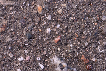 the texture of old asphalt. a lot of small stones of different colors, granite chips