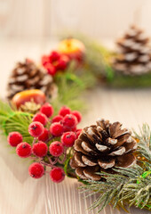 Christmas wreath on light wooden background closeup