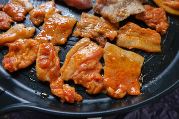 Korean traditional grilled BBQ food, samgyupsal, pork with gochujang and Grilled Pork Neck on hot pan, Food for camping in winter.