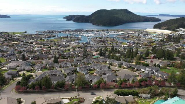 Cinematic 4K aerial drone trucking footage of Burrows Pass and Island, Tugboat Beach, Portalis, Anaco Beach, Washington Park, Anacortes waterfront, a charming, quaint old town near Seattle