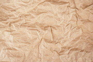 Background image of rough crumpled recycled textured kraft paper. Top view, copy space