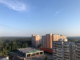 view from the window of a multi-storey building on the forest. summer, Russia