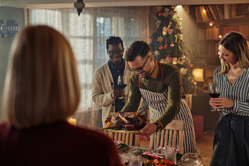 Man serving food on dining table during Christmas party