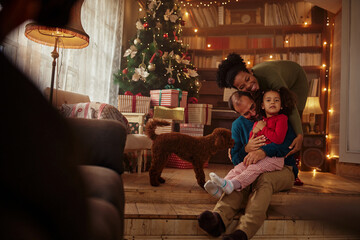 Obraz na płótnie Canvas Young family celebrating Christmas at home.