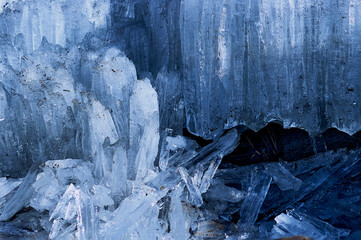 Melting river ice. Columnar and needle-like structure of crystals. Shine and reflections of the...