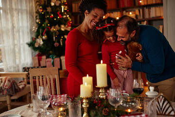 Merry Christmas! Happy family are having dinner at home.