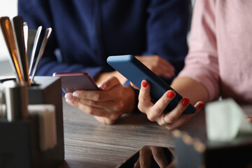 People hold mobile phones in hands