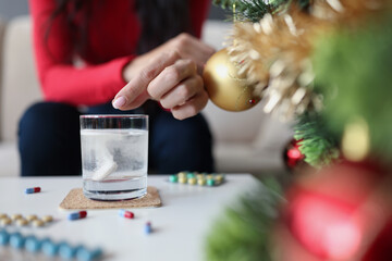 Close-up of female hand putting effervescent tablet