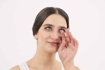 The girl cries with happiness and wipes tears from her cheeks with her hand. Tears of happiness.